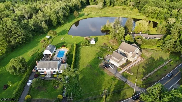 an aerial view of a house with a yard and trees