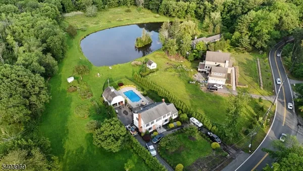 an aerial view of a house with a yard basket ball court and outdoor seating