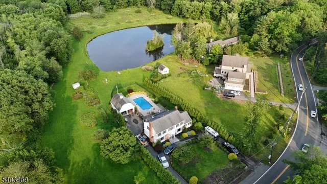 an aerial view of a house with a yard basket ball court and outdoor seating
