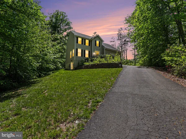 a front view of a house with a yard and pathway