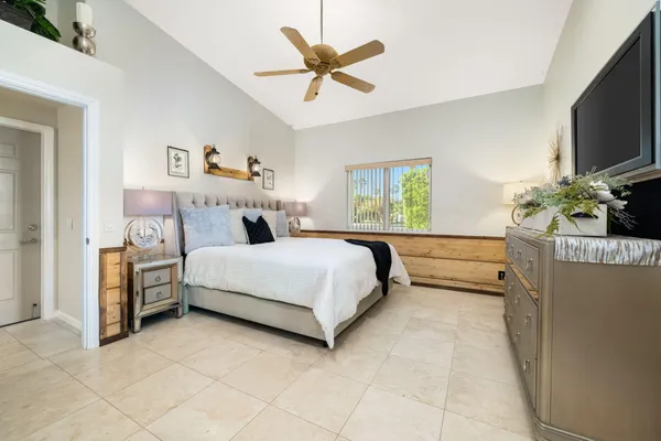 a bedroom with a bed and flat screen tv