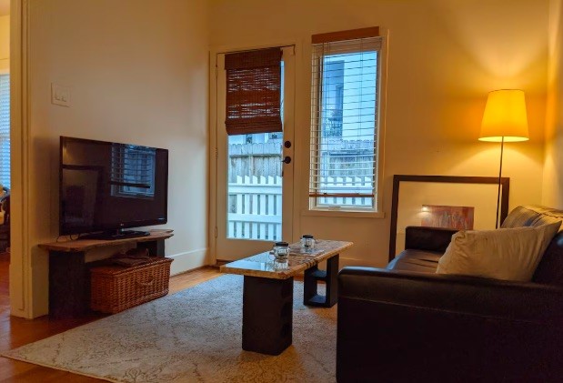 4204 Stanford Street Houston, TX 77006 - Photo 14 of 19 a living room with furniture and a flat screen tv