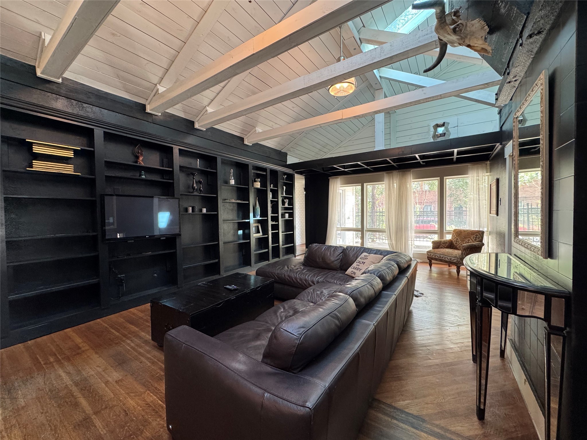 4204 Stanford Street Houston, TX 77006 - Photo 4 of 19 a living room with furniture a flat screen tv and floor to ceiling window