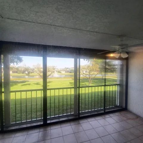 a kitchen with stainless steel appliances granite countertop a refrigerator a sink a stove and white cabinets