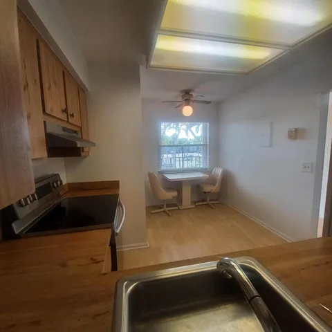 a kitchen with stainless steel appliances a refrigerator stove microwave and sink