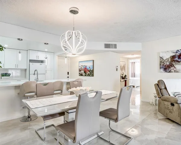 a living room with lots of furniture and a chandelier