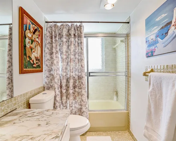 a bathroom with a toilet sink and shower