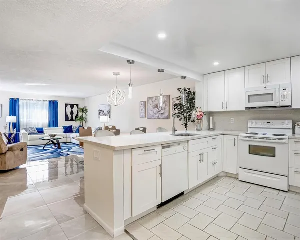 a kitchen with cabinets appliances and a counter