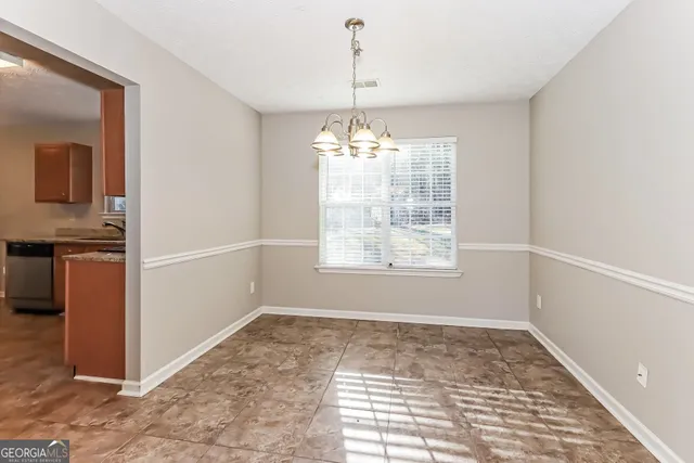 an empty room with windows and entrance