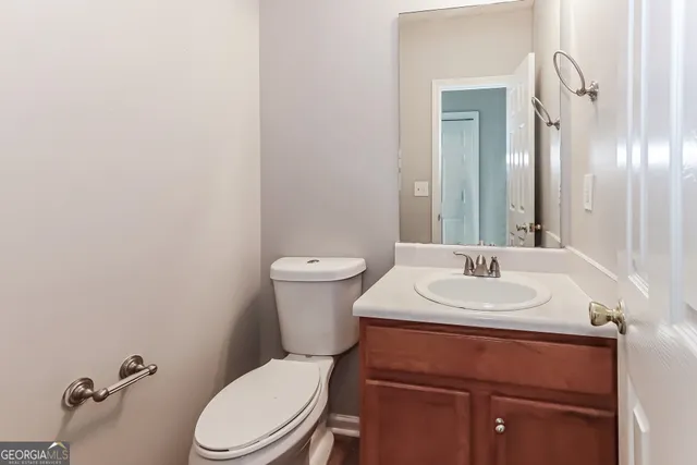 a bathroom with a toilet a sink and mirror