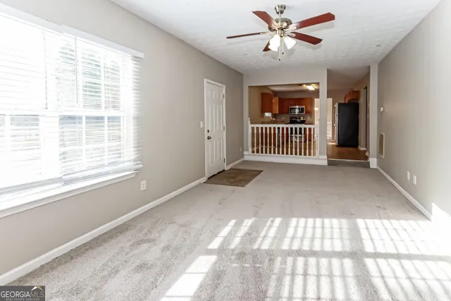 a view of livingroom with a ceiling fan and window