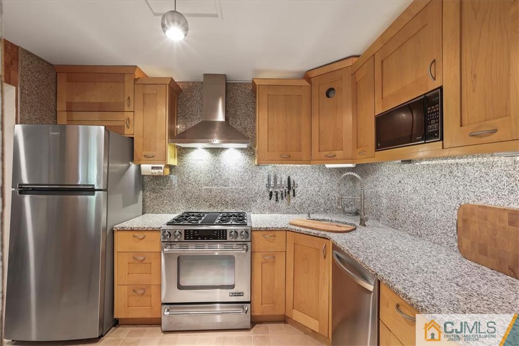 809 Meadow Court, Unit 809 Helmetta, NJ 08828 - Photo 3 of 8 a kitchen with stainless steel appliances granite countertop a stove a refrigerator and a microwave