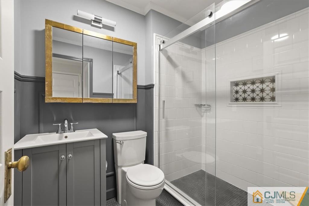809 Meadow Court, Unit 809 Helmetta, NJ 08828 - Photo 4 of 8 a bathroom with a sink a toilet and shower