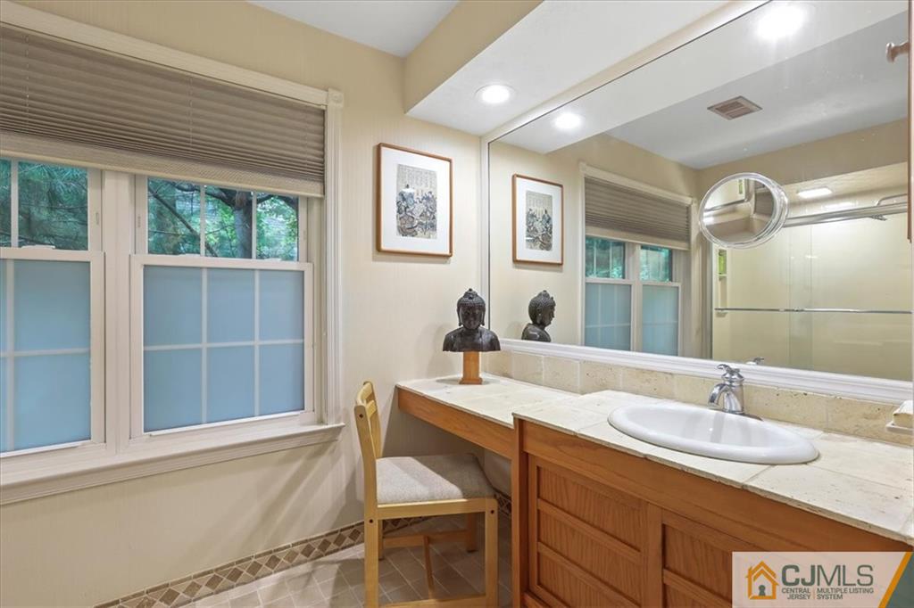 809 Meadow Court, Unit 809 Helmetta, NJ 08828 - Photo 5 of 8 a bathroom with a sink and a mirror