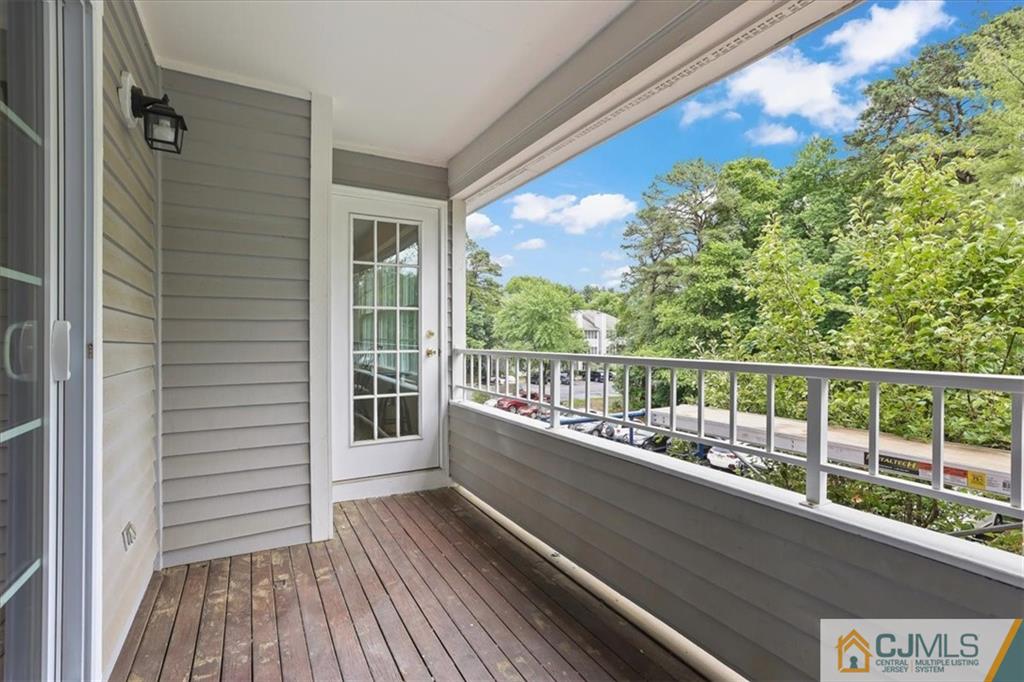 809 Meadow Court, Unit 809 Helmetta, NJ 08828 - Photo 7 of 8 a view of balcony with wooden floor