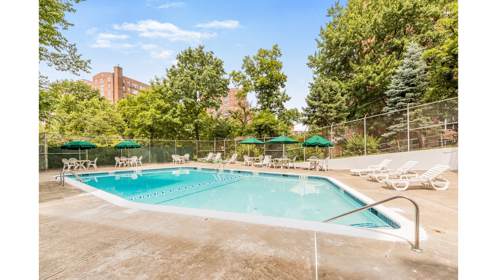 601 Kappock Street, Unit 2F Bronx, NY 10463 - Photo 13 of 15 a view of a swimming pool with a lawn chairs under an umbrella