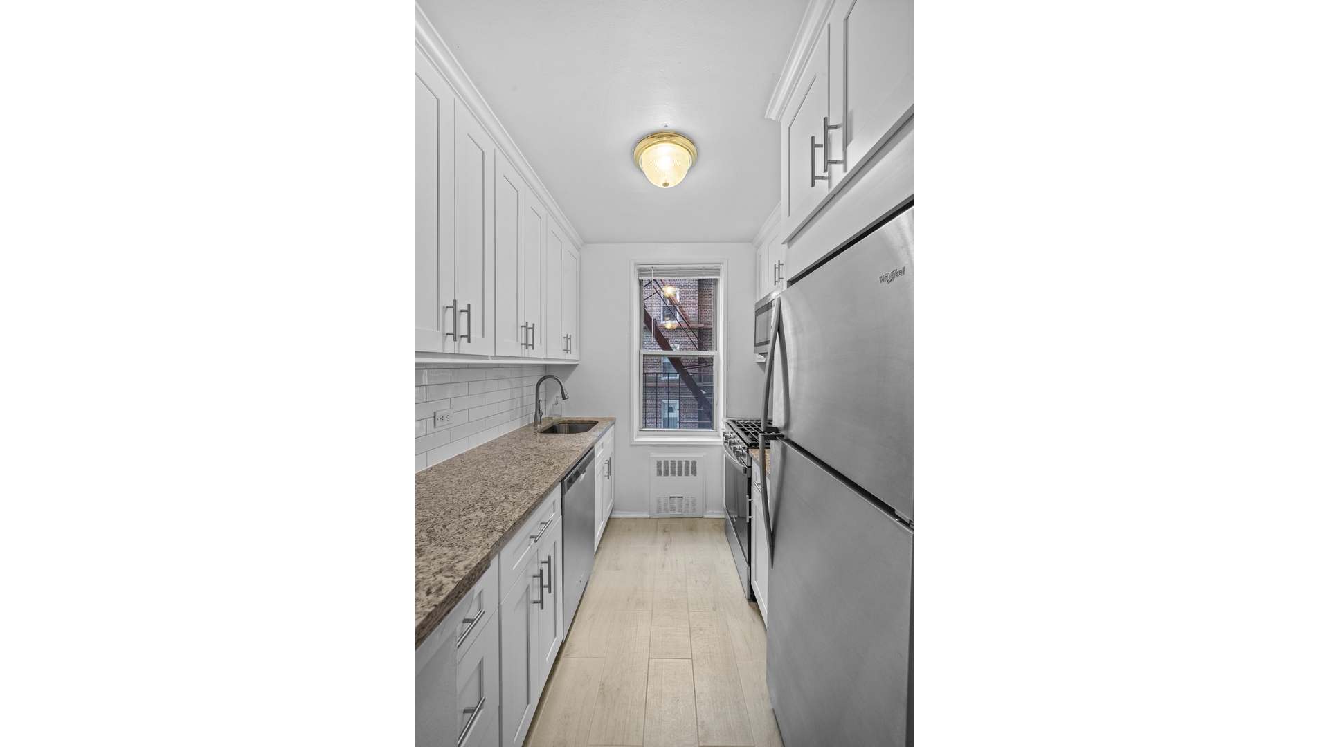 601 Kappock Street, Unit 2F Bronx, NY 10463 - Photo 6 of 15 a kitchen with a sink and refrigerator