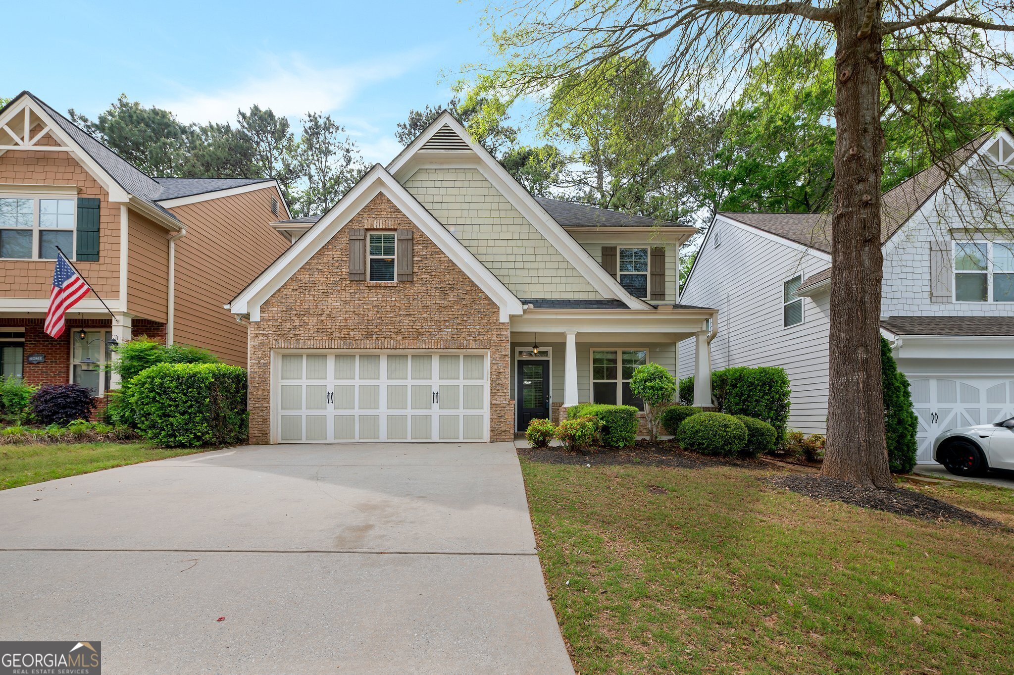a front view of a house with a yard and garage