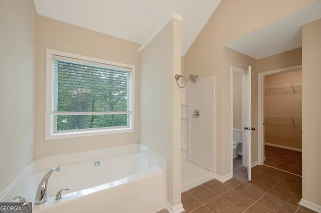 a bathroom with a bathtub and shower
