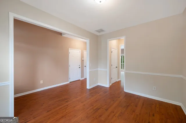 a view of wooden floor and windows in a room