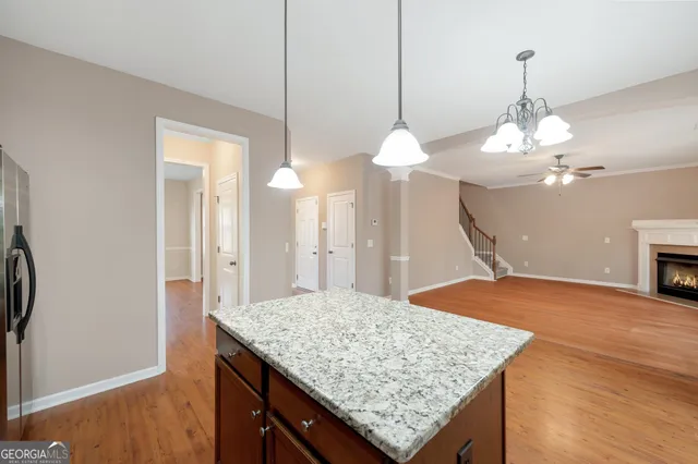 a view of a kitchen island cabinets and wooden floor