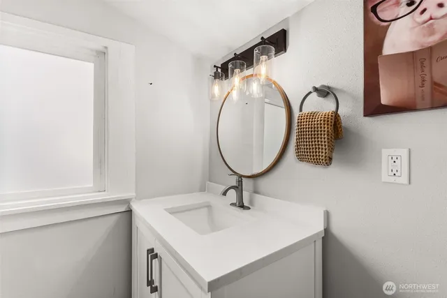 a view of a white house with a yard and lawn chairs