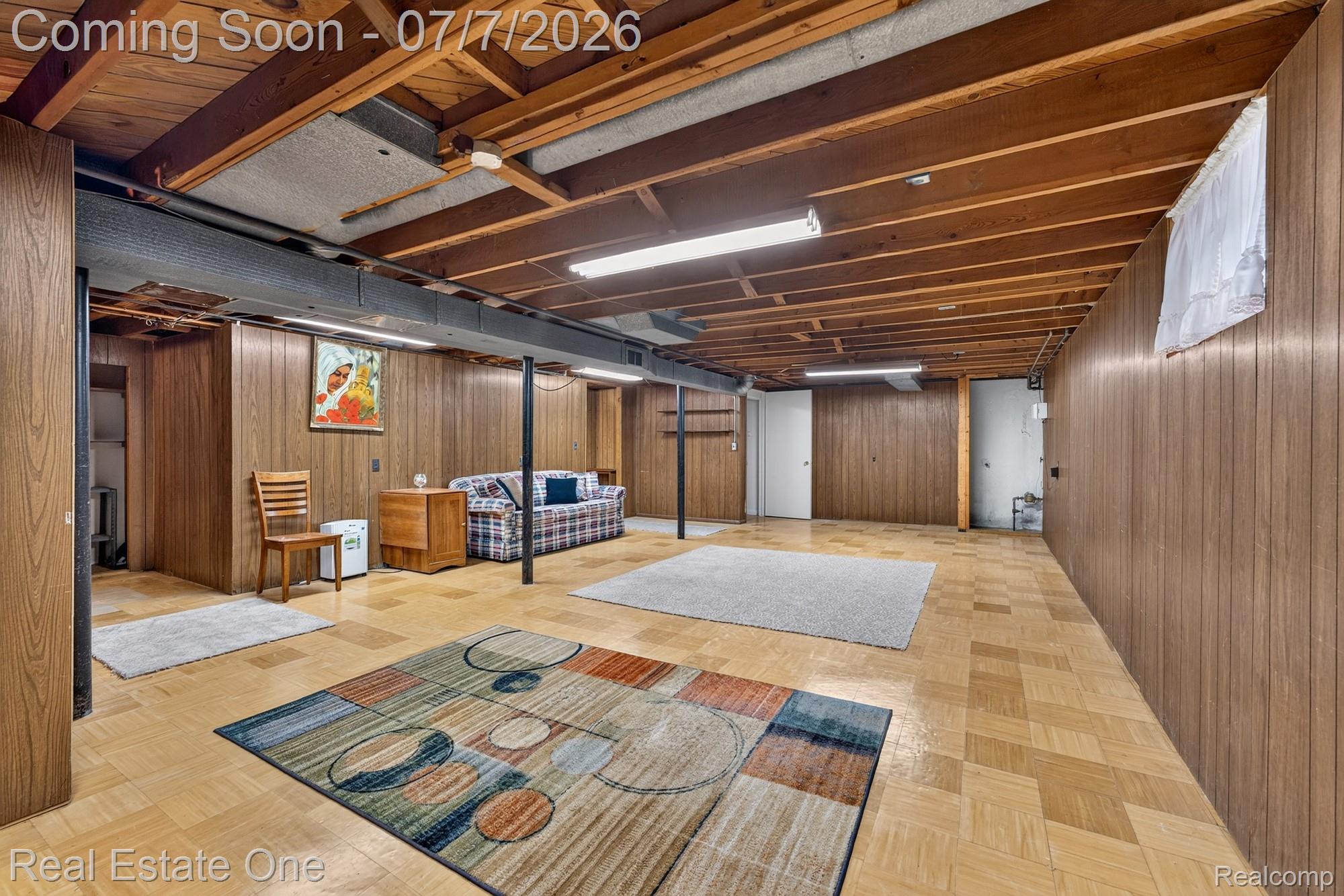 24749 Munson Street Taylor, MI 48180 - Photo 19 of 28 Expansive lower level featuring wood-finish paneling and an exposed wood beam ceiling
