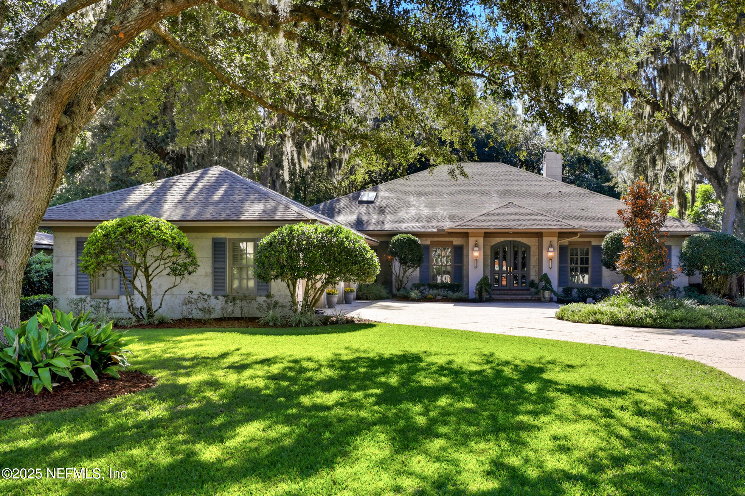 a view of a house with a yard and sitting area