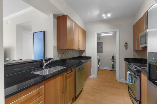 a kitchen with granite countertop a sink and cabinets