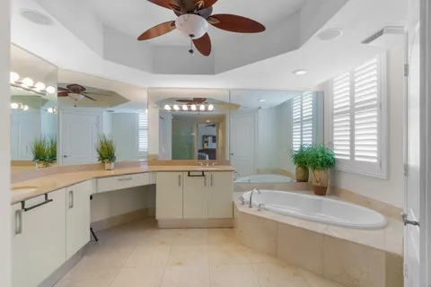 a large white kitchen with a large tub and sink
