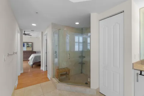 a bathroom with a glass shower door and a sink