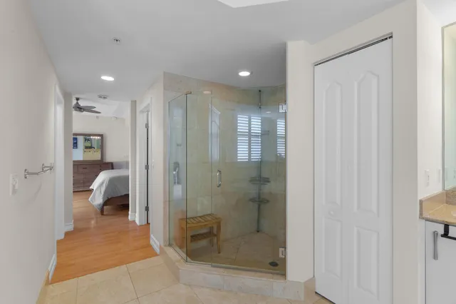a bathroom with a glass shower door and a sink