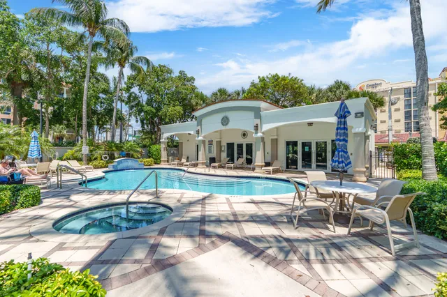 a view of a house with swimming pool and sitting area