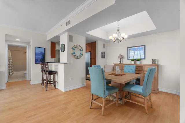 a view of a dining room with furniture and chandelier