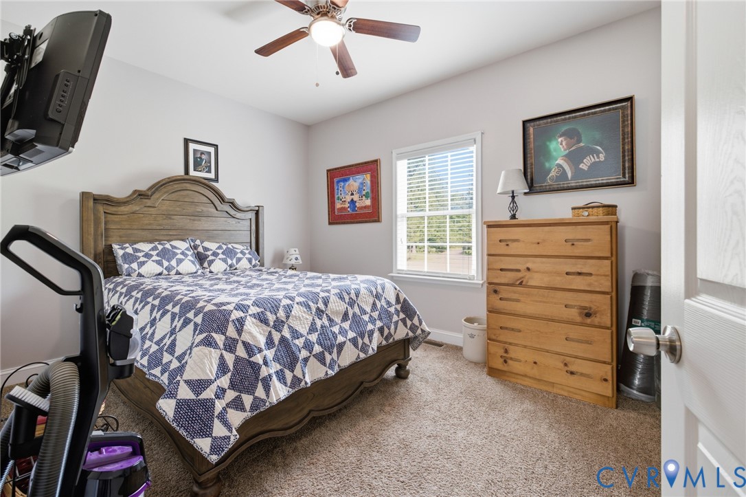 9433 Robin Road Disputanta, VA 23842 - Photo 18 of 26 Carpeted room featuring a ceiling fan with integra