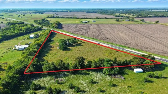 an aerial view of a houses with a yard