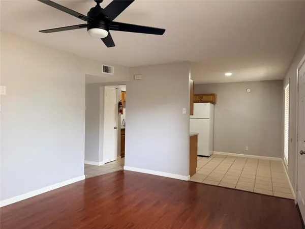 a view of an empty room and wooden floor