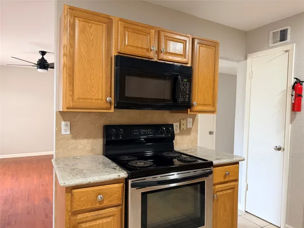 a kitchen with stainless steel appliances granite countertop a sink and cabinets