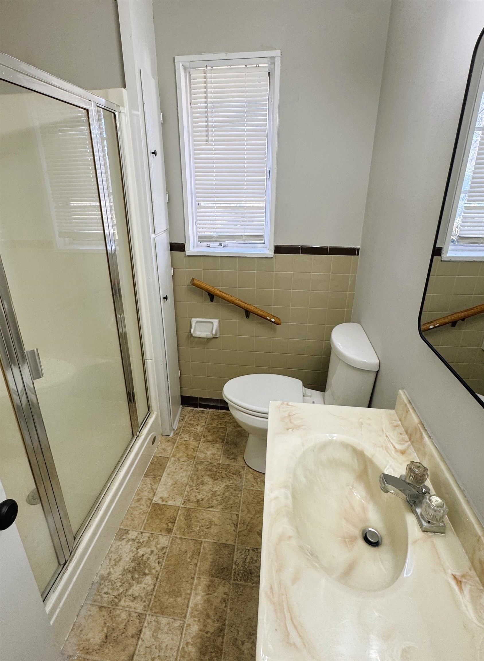 4956 Owen Road Memphis, TN 38122 - Photo 9 of 14 Bathroom featuring a shower stall, vanity, a wainscoted wall, and tile walls