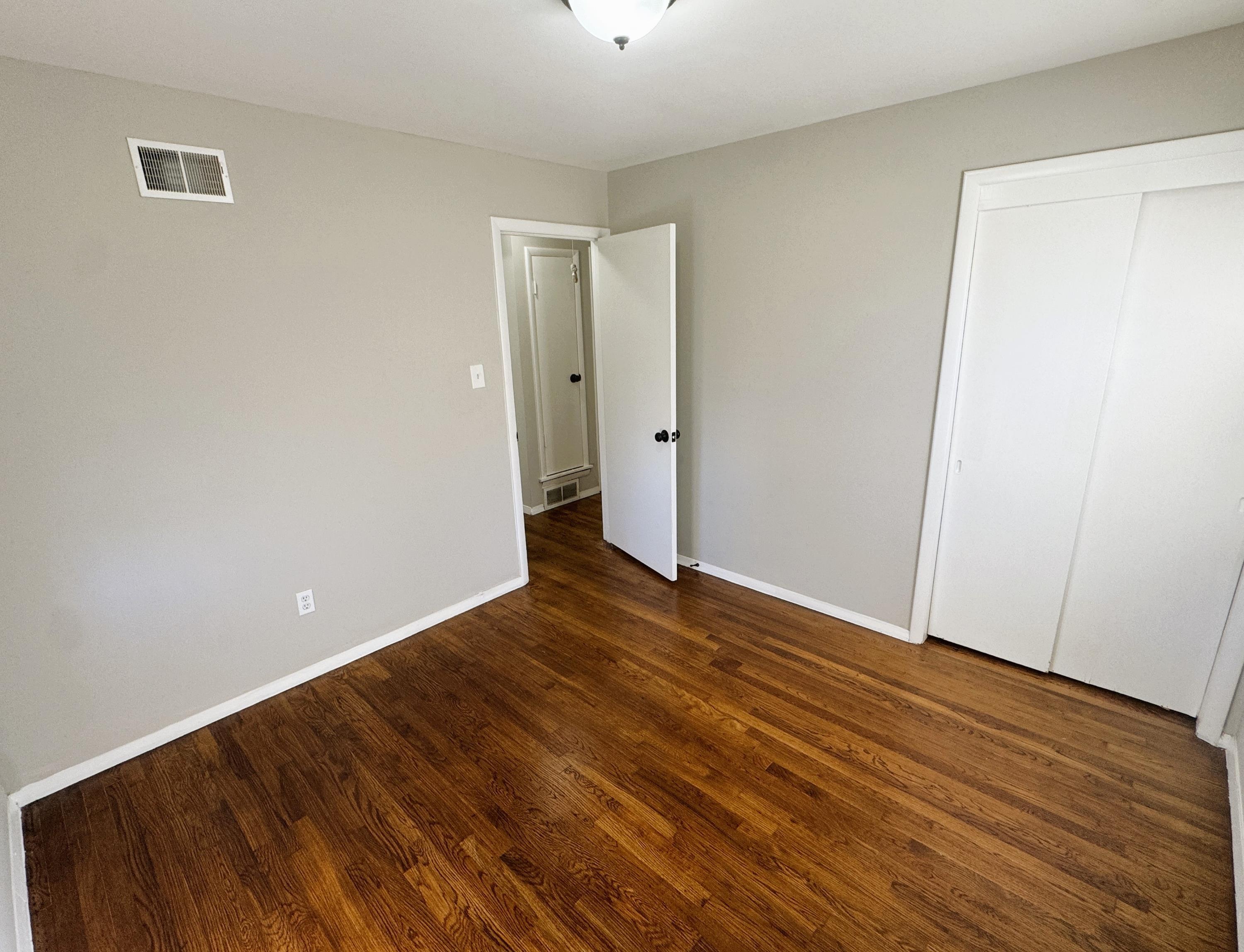 4956 Owen Road Memphis, TN 38122 - Photo 10 of 14 Unfurnished bedroom featuring dark wood finished floors and a closet