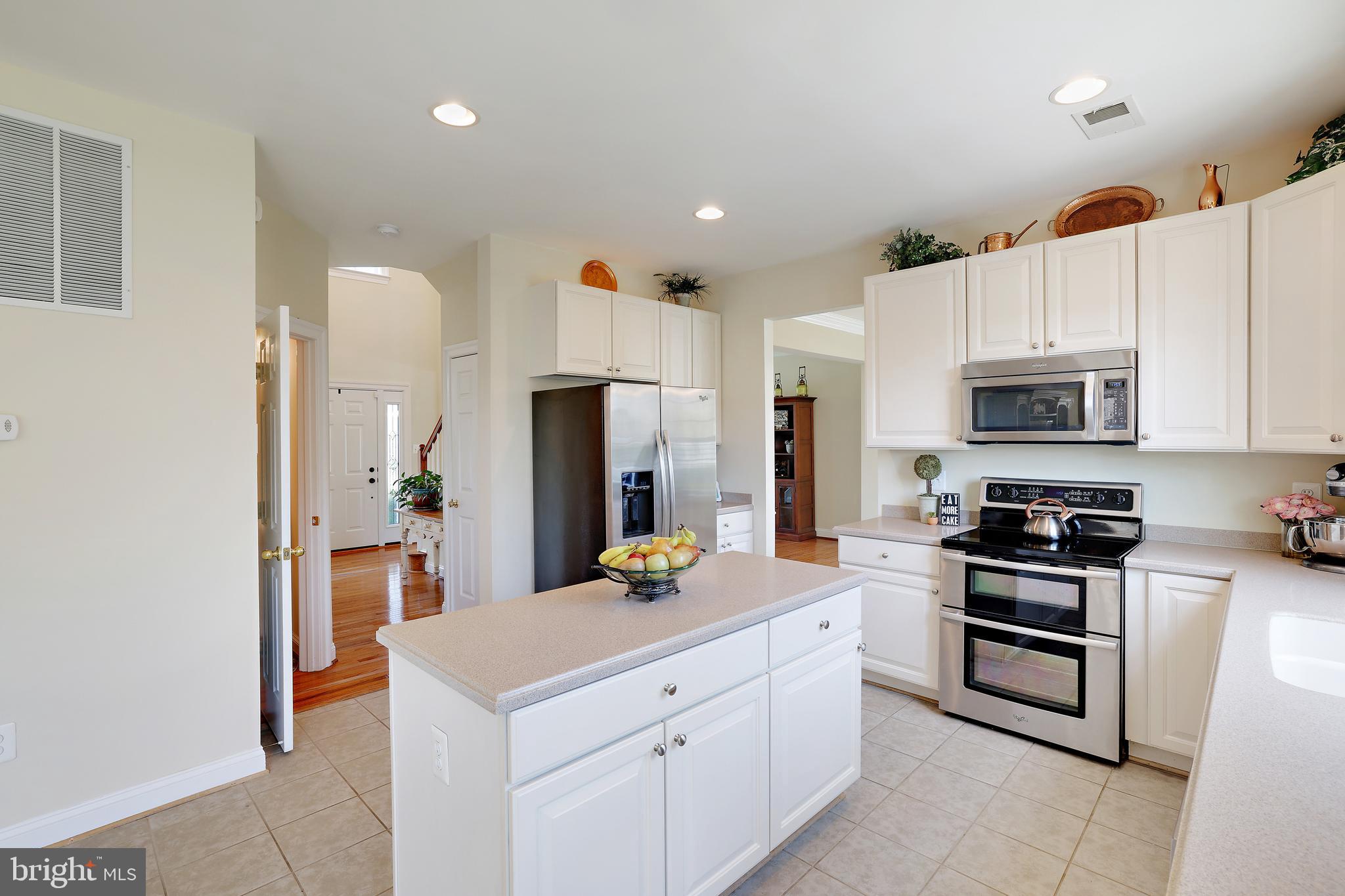 8301 Banister Road Severn, MD 21144 - Photo 20 of 57 a kitchen with stainless steel appliances a stove refrigerator sink and microwave