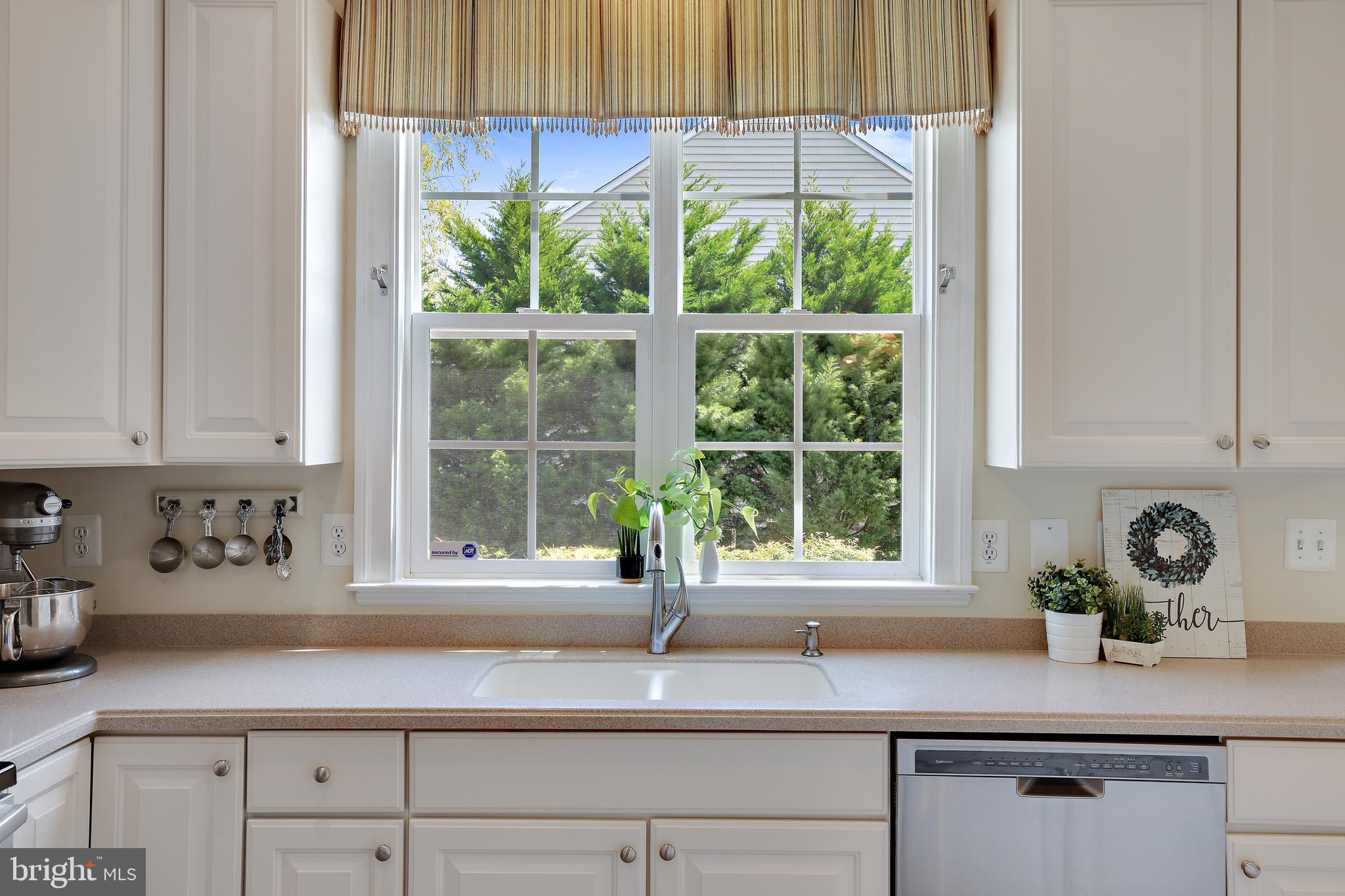8301 Banister Road Severn, MD 21144 - Photo 21 of 57 a kitchen with stainless steel appliances white cabinets a window and a sink