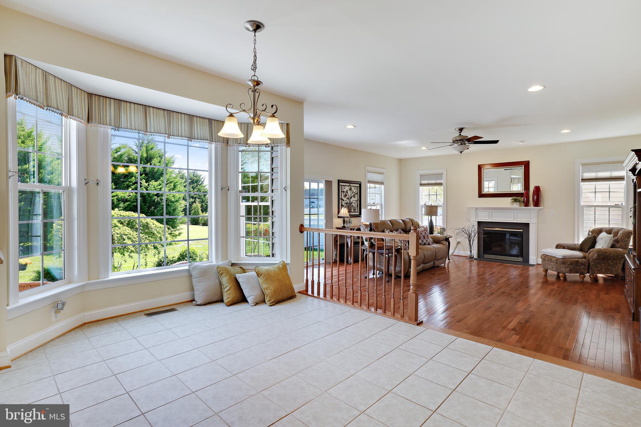8301 Banister Road Severn, MD 21144 - Photo 23 of 57 a living room with furniture a fireplace and a chandelier