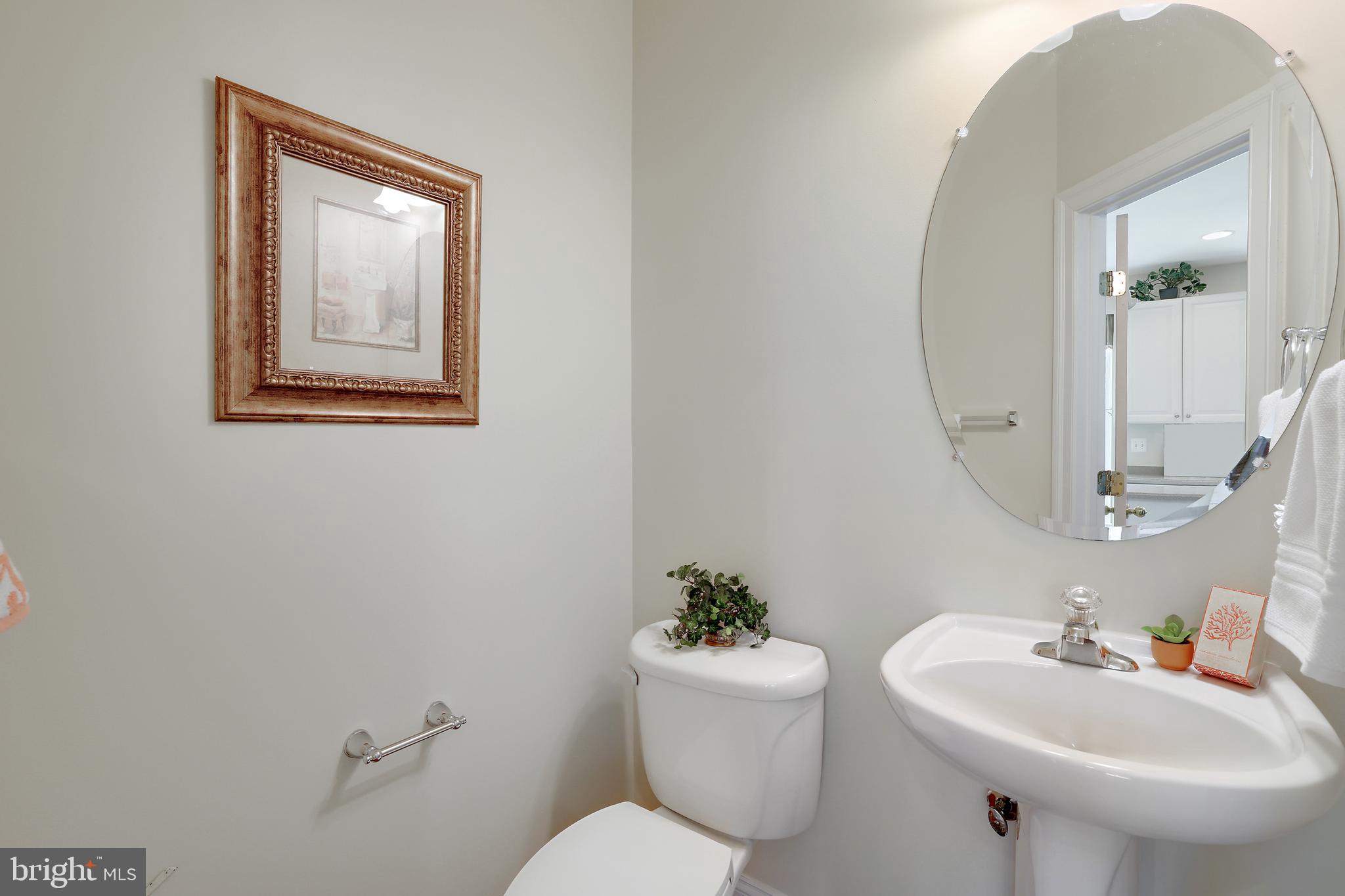8301 Banister Road Severn, MD 21144 - Photo 29 of 57 a bathroom with a toilet sink and mirror