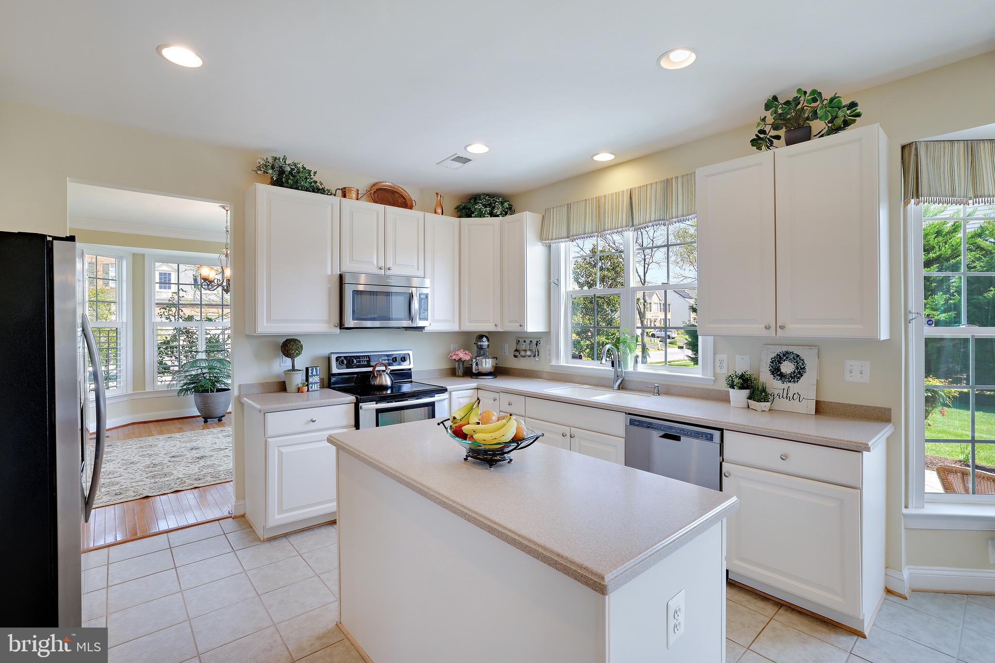 8301 Banister Road Severn, MD 21144 - Photo 4 of 57 a kitchen with a sink a counter top space cabinets and stainless steel appliances