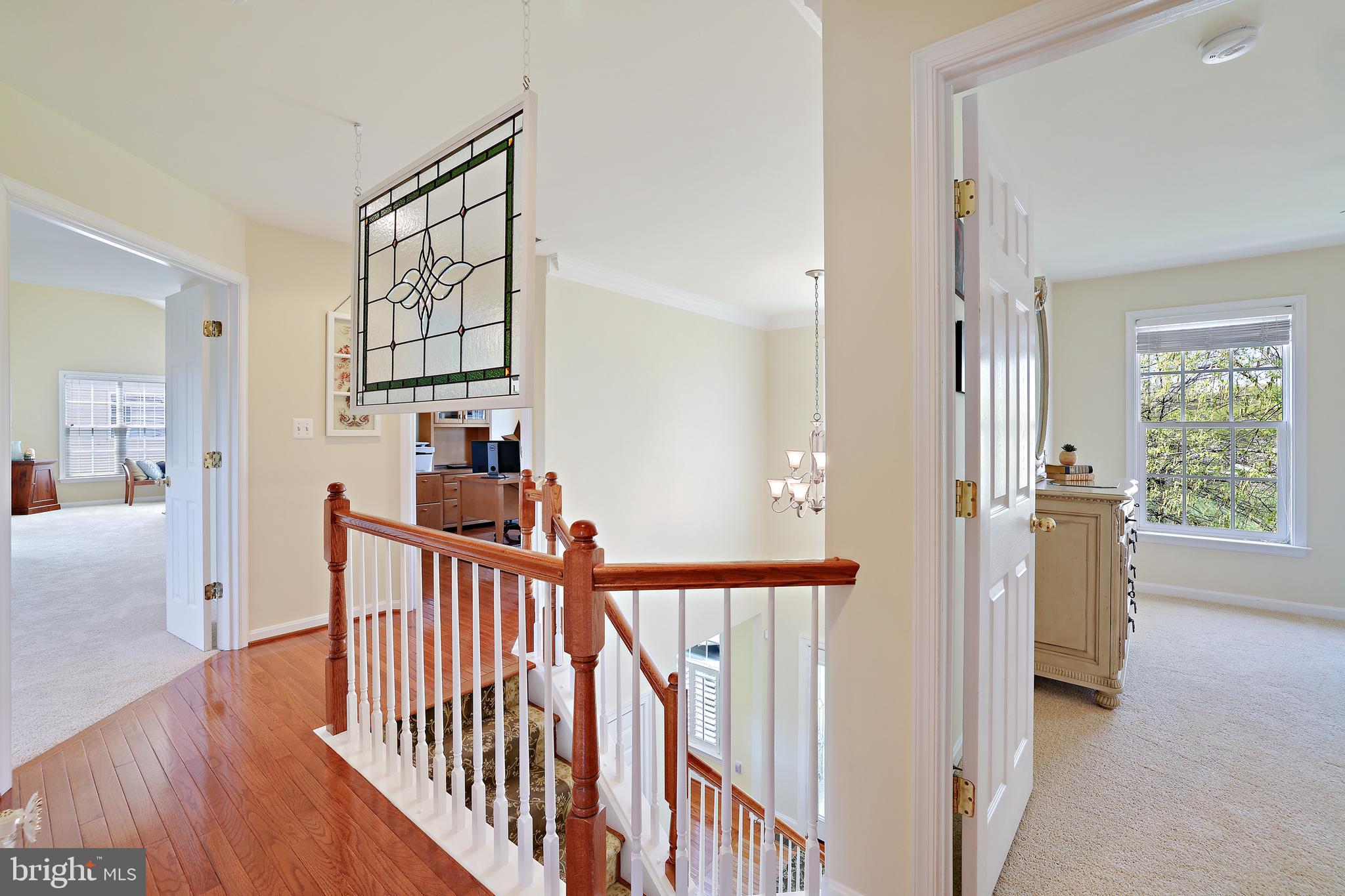 8301 Banister Road Severn, MD 21144 - Photo 31 of 57 a view of a hallway with wooden floor and windows