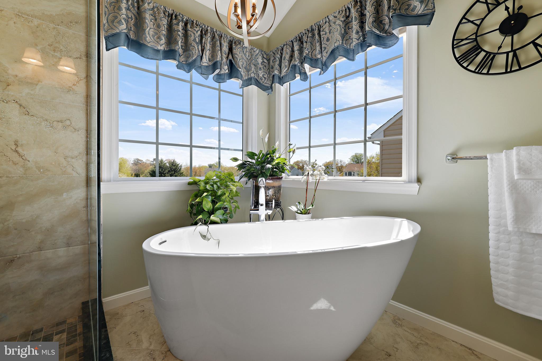 8301 Banister Road Severn, MD 21144 - Photo 36 of 57 a white bath tub sitting in a bathroom next to a window