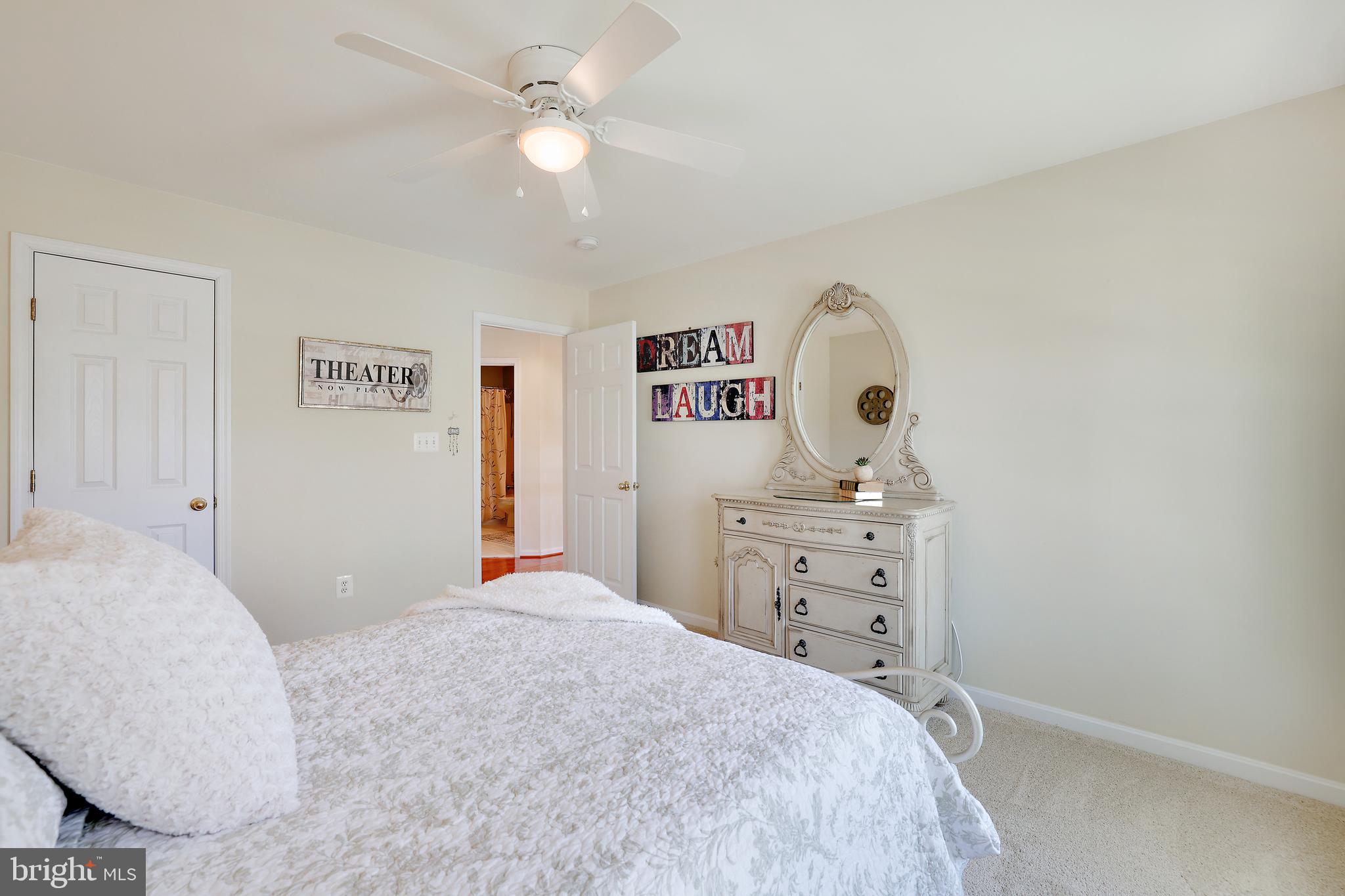 8301 Banister Road Severn, MD 21144 - Photo 41 of 57 a bedroom with a bed and a chandelier
