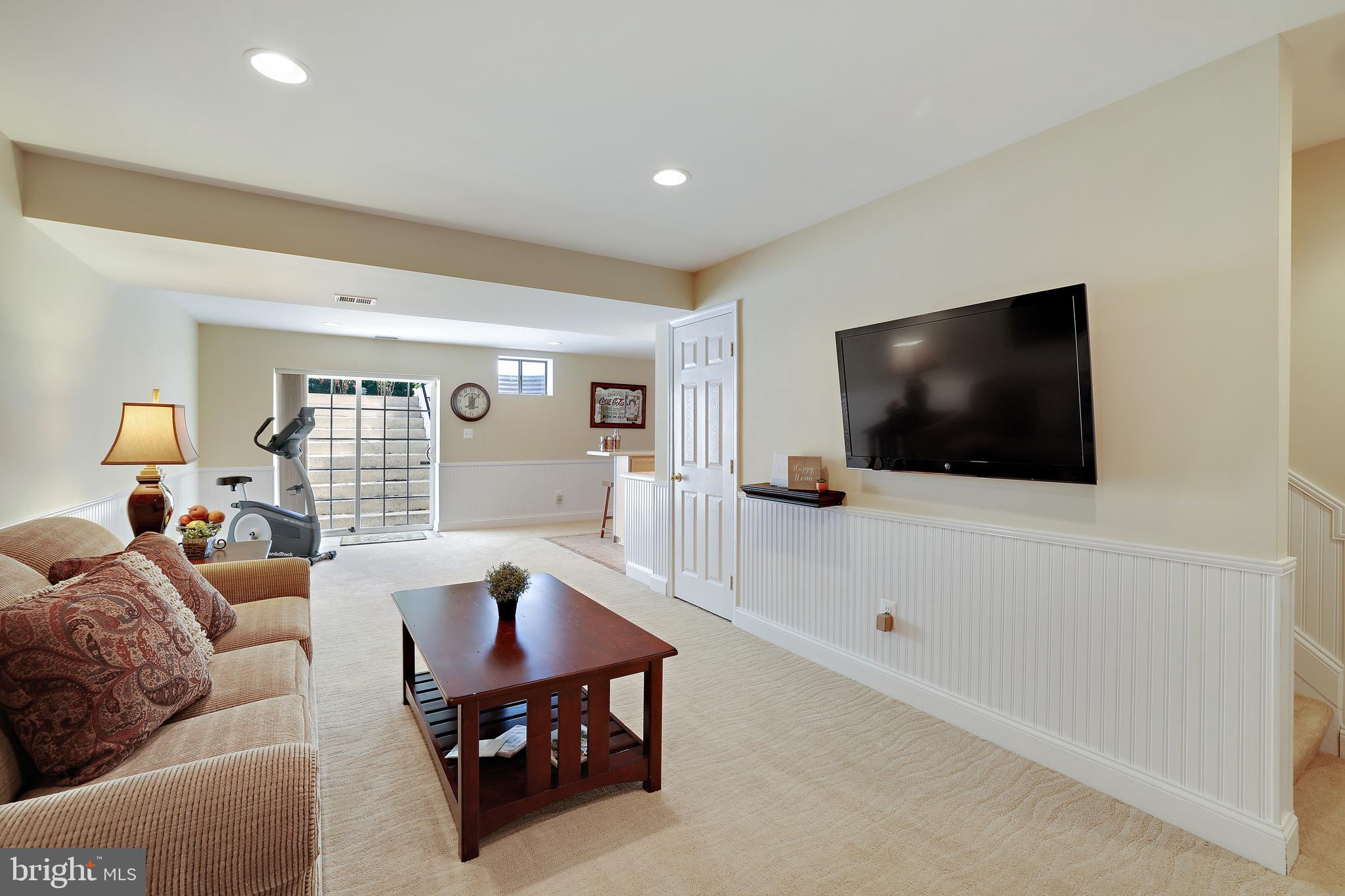 8301 Banister Road Severn, MD 21144 - Photo 46 of 57 a living room with furniture and a flat screen tv