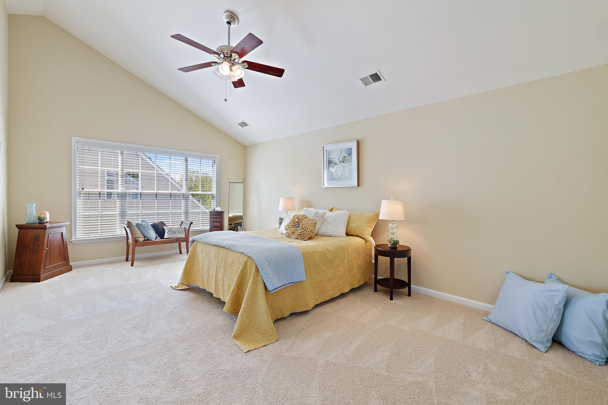 8301 Banister Road Severn, MD 21144 - Photo 6 of 57 a spacious bedroom with a bed and a large window